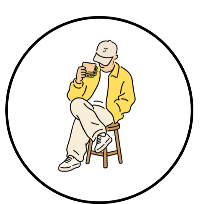 Someone in a Jab's cap on a stool, sandwich in one hand